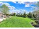 Large grassy backyard with a stone firepit area, perfect for entertaining at 11509 Wildlife Ct, Zionsville, IN 46077