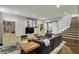 Finished basement featuring a large sectional sofa, entertainment center, and staircase to the main floor at 11509 Wildlife Ct, Zionsville, IN 46077