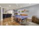 Finished basement with ping pong table, wet bar, seating, and space for recreation and entertainment at 11509 Wildlife Ct, Zionsville, IN 46077