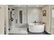 A luxurious bathroom features a soaking tub and walk-in shower with modern black fixtures at 11509 Wildlife Ct, Zionsville, IN 46077