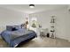 A vibrant bedroom with a full bed, desk and shelving, and a view from the window at 11509 Wildlife Ct, Zionsville, IN 46077