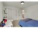 A well-lit bedroom features a closet and a desk, complete with a view from the window at 11509 Wildlife Ct, Zionsville, IN 46077