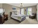 Comfortable bedroom featuring neutral walls, carpet flooring, and a large bed with soft pillows at 11509 Wildlife Ct, Zionsville, IN 46077