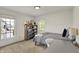 A well-lit bedroom with a large window next to a bookcase filled with toys and books at 11509 Wildlife Ct, Zionsville, IN 46077