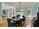 Elegant dining room with hardwood floors, a modern light fixture, and views of the entryway at 11509 Wildlife Ct, Zionsville, IN 46077