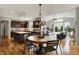Bright dining area offers a round table with seating, modern lighting, and an open view to the adjoining kitchen at 11509 Wildlife Ct, Zionsville, IN 46077