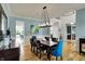 Open-concept dining room featuring hardwood floors, modern lighting, and views of the living spaces at 11509 Wildlife Ct, Zionsville, IN 46077