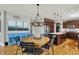 Charming dining area features a round wooden table, stylish chairs, and a pop of color with the blue credenza at 11509 Wildlife Ct, Zionsville, IN 46077