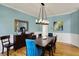 Bright dining room with hardwood floors, elegant wainscoting, and a modern light fixture at 11509 Wildlife Ct, Zionsville, IN 46077