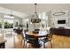 Elegant dining space with vaulted ceilings, hardwood floors, and an open layout to the living room and backyard at 11509 Wildlife Ct, Zionsville, IN 46077