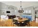 Spacious dining area with hardwood floors, modern lighting, and an open floor plan to the living room and kitchen at 11509 Wildlife Ct, Zionsville, IN 46077