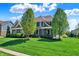 Beautiful home with mature trees, manicured lawn, and a classic brick and siding exterior at 11509 Wildlife Ct, Zionsville, IN 46077
