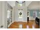 Bright foyer boasts hardwood floors, high ceilings, a chandelier, and a view of the staircase at 11509 Wildlife Ct, Zionsville, IN 46077