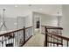 Second floor hallway with carpeted floors and wood railing at 11509 Wildlife Ct, Zionsville, IN 46077
