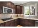 Close-up view of a kitchen with modern cabinets, tile backsplash, and stainless steel appliances at 11509 Wildlife Ct, Zionsville, IN 46077