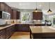 Modern kitchen with wooden cabinets, stainless steel appliances, and bright countertops at 11509 Wildlife Ct, Zionsville, IN 46077