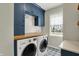 This laundry room features modern washer and dryer and plenty of storage at 11509 Wildlife Ct, Zionsville, IN 46077