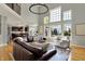 Inviting open-concept living area with large windows, hardwood floors, and a comfortable seating arrangement for entertaining at 11509 Wildlife Ct, Zionsville, IN 46077