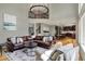 Open-concept living space showcases hardwood floors, a stylish rug, and a comfortable sectional sofa with decorative pillows at 11509 Wildlife Ct, Zionsville, IN 46077