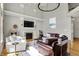 Beautiful living room with soaring ceilings, a cozy fireplace, and a comfortable seating arrangement, perfect for relaxation at 11509 Wildlife Ct, Zionsville, IN 46077