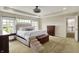 Inviting main bedroom with tray ceilings and large windows at 11509 Wildlife Ct, Zionsville, IN 46077