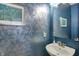 Stylish powder room features custom painting, modern sink and fixtures at 11509 Wildlife Ct, Zionsville, IN 46077