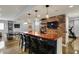 Finished basement with wet bar area with seating, brick accent wall, ping pong table, and exercise equipment at 11509 Wildlife Ct, Zionsville, IN 46077