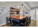 Finished basement wet bar area with brick accent wall, bar tap, wood countertop, and seating for entertaining at 11509 Wildlife Ct, Zionsville, IN 46077
