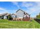 Spacious backyard featuring a well-manicured lawn, a wooden deck, and a patio with comfortable seating, perfect for entertaining at 11685 Platt St, Noblesville, IN 46060