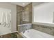 Bright bathroom with a glass-enclosed shower, soaking tub, and towel rack at 11685 Platt St, Noblesville, IN 46060