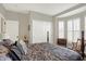 Inviting bedroom features a sliding door closet, a bay window with shutters, and a comfortable bed at 11685 Platt St, Noblesville, IN 46060