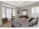 Cozy bedroom features a bay window with seating, a decorative mirror, and a comfortable bed at 11685 Platt St, Noblesville, IN 46060