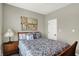 Well-lit bedroom with modern painting, wood furnishings, comfortable bed and carpet at 11685 Platt St, Noblesville, IN 46060