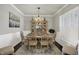 Formal dining room with a classic chandelier, wood floors, and large windows, creating a sophisticated and inviting space at 11685 Platt St, Noblesville, IN 46060