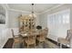 Formal dining room with a classic chandelier, wood floors, and large windows, creating a sophisticated and inviting space at 11685 Platt St, Noblesville, IN 46060