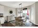 Bright dining area features modern lighting and a sliding glass door to the patio, offering a seamless transition to outdoor living at 11685 Platt St, Noblesville, IN 46060