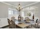 Dining room with white trim, featuring an elegant chandelier and ample natural light, perfect for Gathering gatherings and entertaining at 11685 Platt St, Noblesville, IN 46060