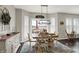 Cozy dining area with modern light fixture, opening to a patio for relaxed indoor-outdoor living and entertaining at 11685 Platt St, Noblesville, IN 46060
