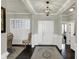 Bright entryway featuring dark hardwood floors, elegant trim work, and a stylish chandelier creating a welcoming ambiance at 11685 Platt St, Noblesville, IN 46060
