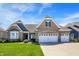 Inviting brick home featuring a well-manicured lawn and a spacious three-car garage, set under a bright, blue sky at 11685 Platt St, Noblesville, IN 46060