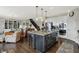 Open kitchen with center island, stainless steel appliances, and seamless flow to the living room at 11685 Platt St, Noblesville, IN 46060