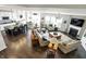 Open-concept living room and kitchen with fireplace, white cabinets, and hardwood floors at 11685 Platt St, Noblesville, IN 46060