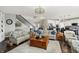 Cozy living room featuring hardwood floors, plush seating, and staircase at 11685 Platt St, Noblesville, IN 46060