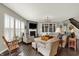 Bright living room with fireplace, built-in shelves, and dark hardwood floors at 11685 Platt St, Noblesville, IN 46060