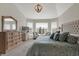 Spacious main bedroom with bay window seating, decorative light fixture, dresser, and tufted headboard at 11685 Platt St, Noblesville, IN 46060