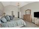 Main bedroom with vaulted ceiling, carpeted floor, dresser with mirror, and patterned comforter at 11685 Platt St, Noblesville, IN 46060