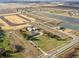 Aerial view showcasing the new construction community featuring homes, a pond, and green spaces at 1268 Fleming Dr, Greenfield, IN 46140