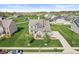 Aerial view of a well-manicured lawn and landscaping in a residential community with a pond at 12894 Corydon Dr, Fishers, IN 46037