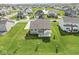 Aerial view of the property showcasing the house, backyard, and neighborhood pond at 12894 Corydon Dr, Fishers, IN 46037
