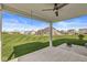 Inviting covered back porch with a ceiling fan and expansive views of the lush green backyard at 12894 Corydon Dr, Fishers, IN 46037